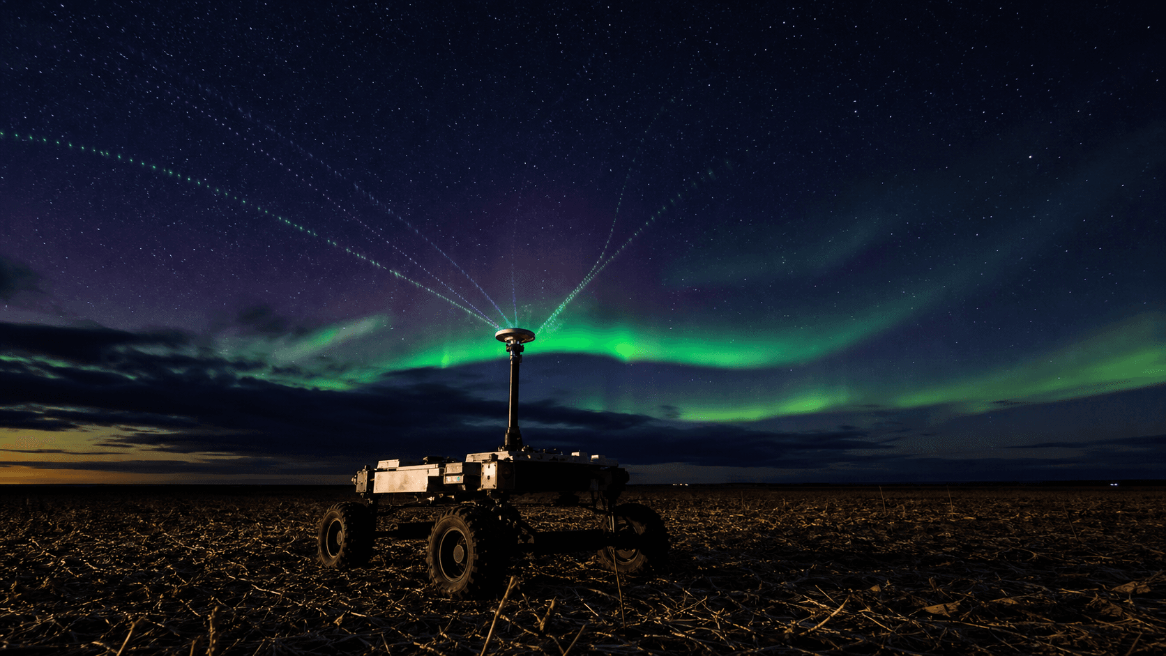 A precision field rover receiving distorted navigation signals beneath a storm-driven aurora