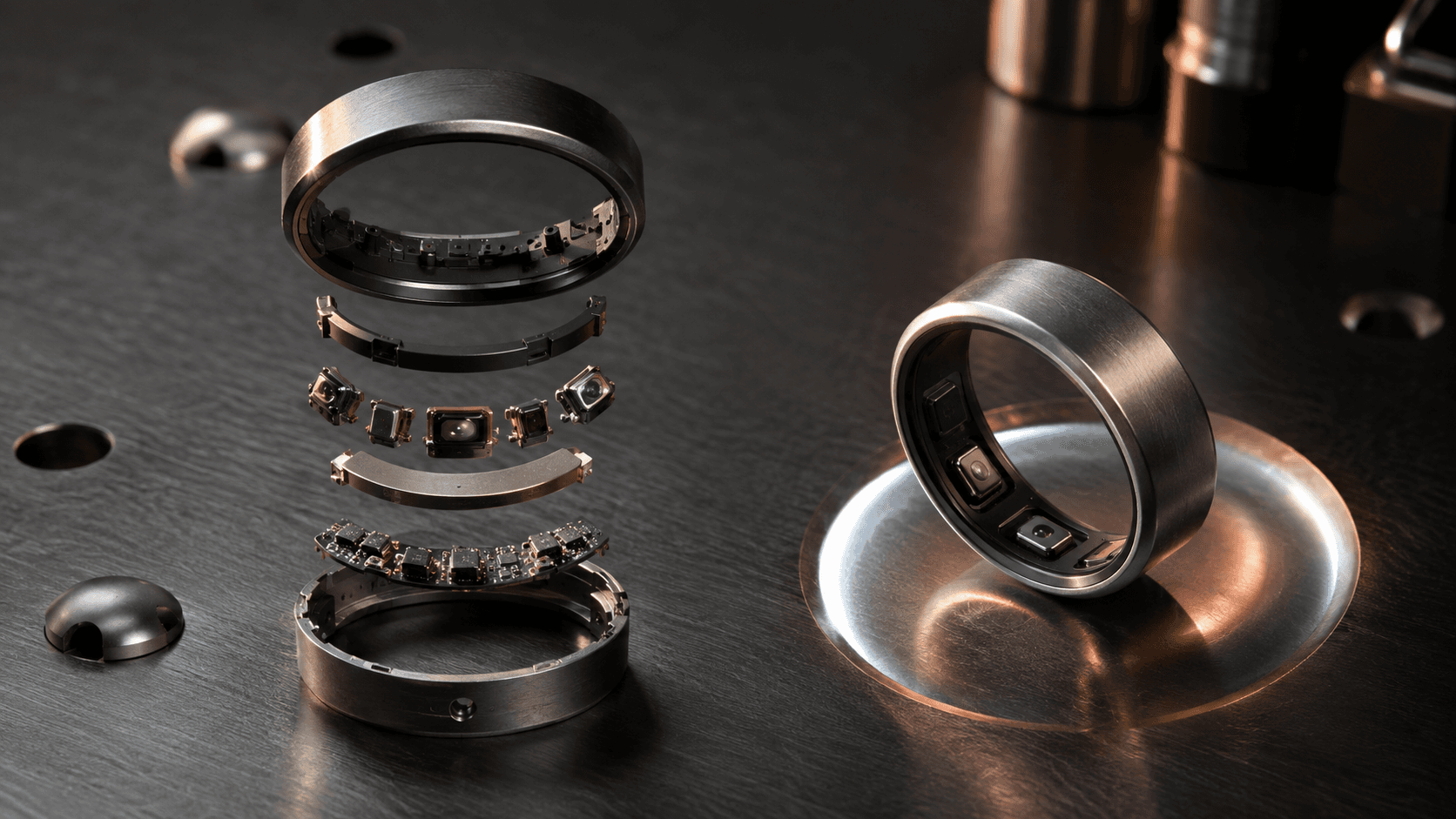 Conceptual editorial photograph of an unbranded wearable ring and its sensor components, not a photograph of Oura hardware or its public offering